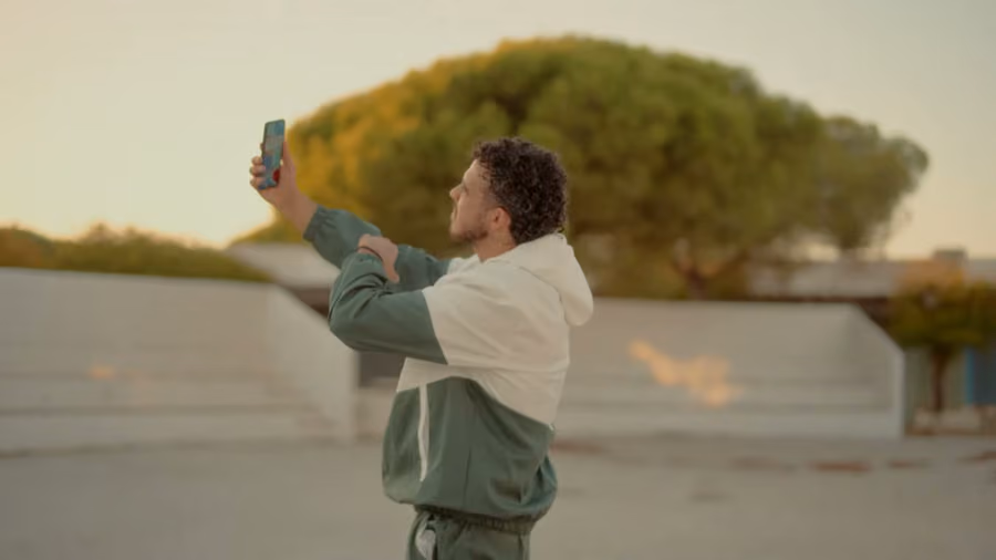 EL KILLO filming a selfie video at golden hour for the Notre Dame music video